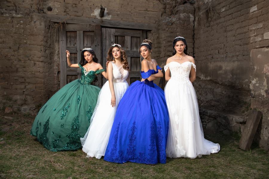 Four young women in green, white and royal blue quinceañera gowns